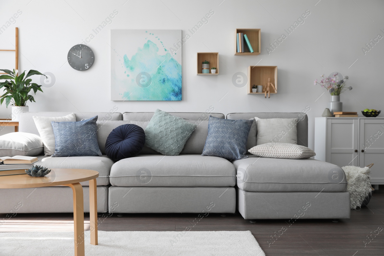 Photo of Elegant living room with comfortable sofa and wooden table. Interior design