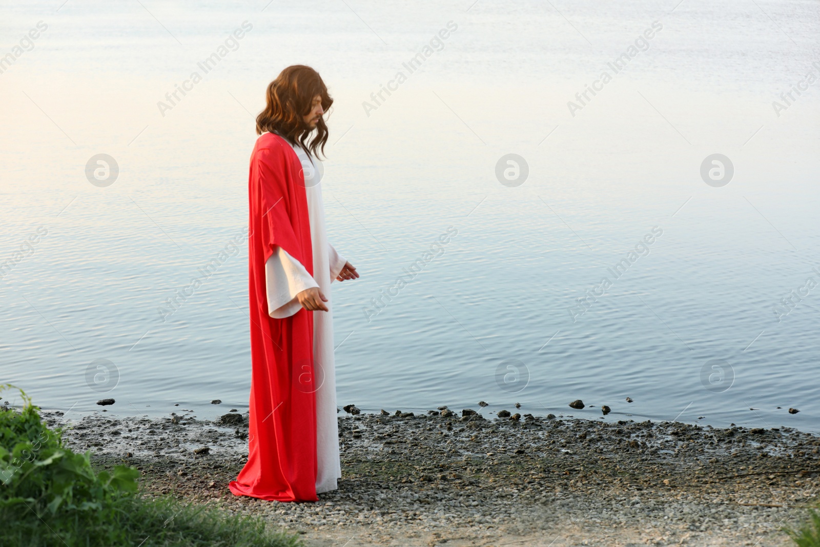 Photo of Jesus Christ near water outdoors. Space for text
