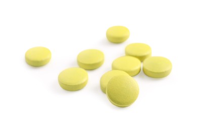 Photo of Many yellow pills isolated on white. Medicinal treatment