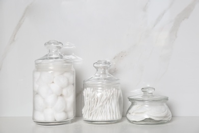 Photo of Cotton balls, swabs and pads on white table indoors