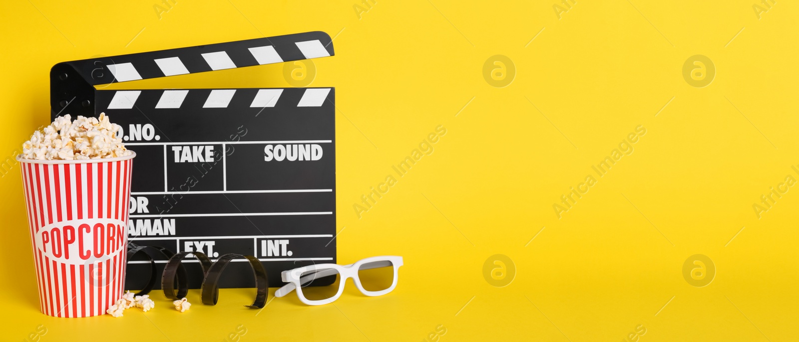 Image of Delicious popcorn, glasses, tape and clapperboard on yellow background. Banner design