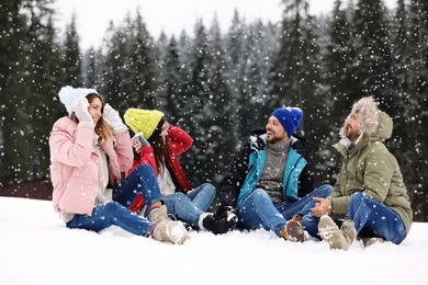 Photo of Group of friends outdoors on snowy day. Winter vacation