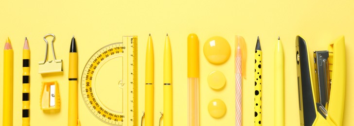 Image of Flat lay composition with different school stationery on yellow background. Banner design