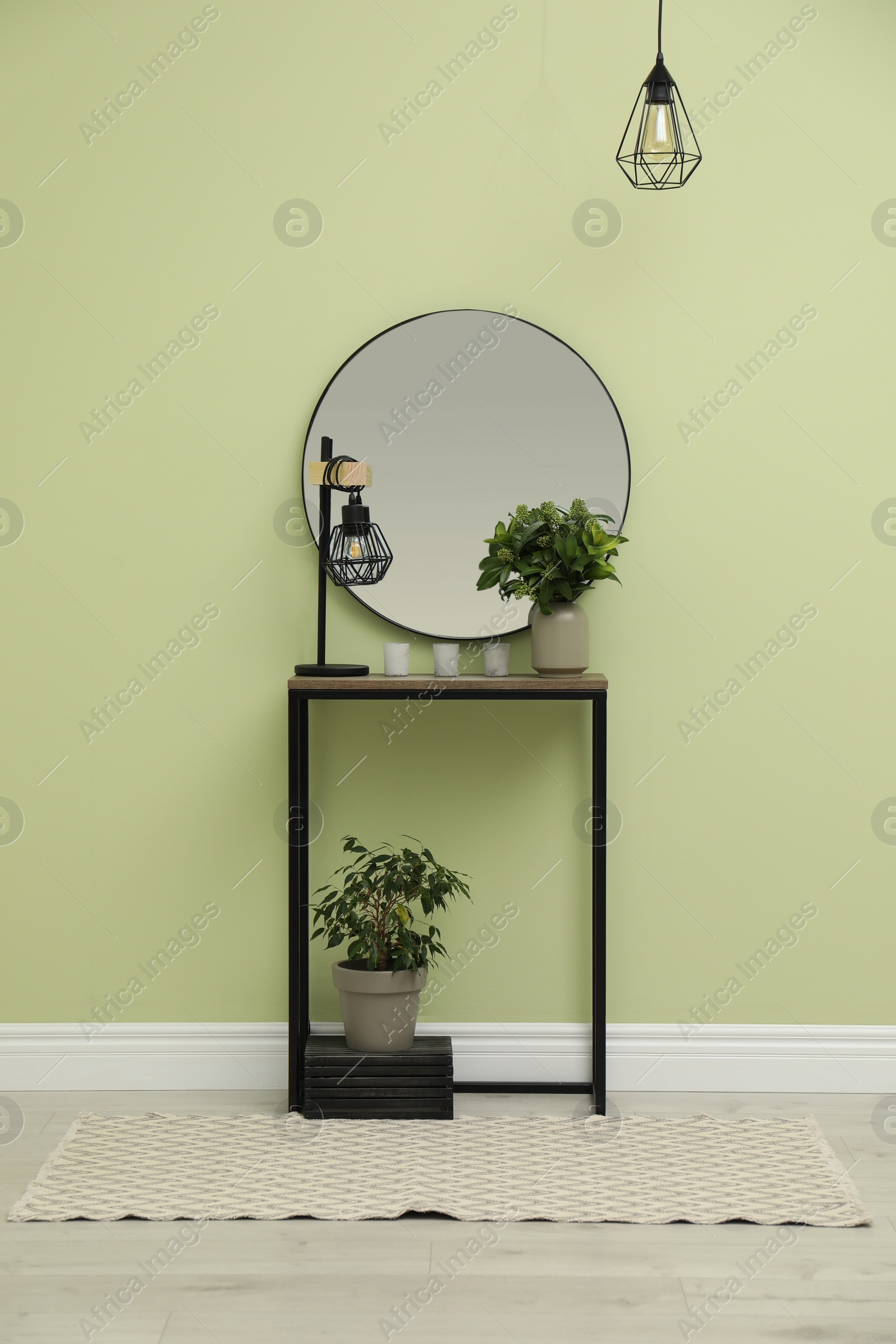 Photo of Hallway with stylish console table and mirror. Interior design