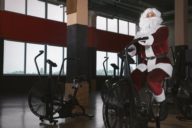 Photo of Young Santa Claus training in modern gym