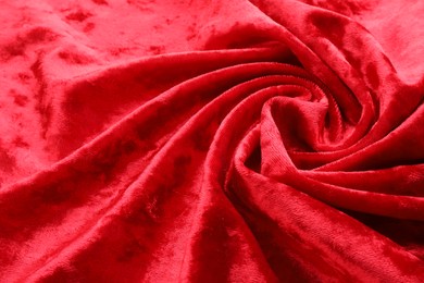 Photo of Texture of crumpled red velvet fabric as background, closeup