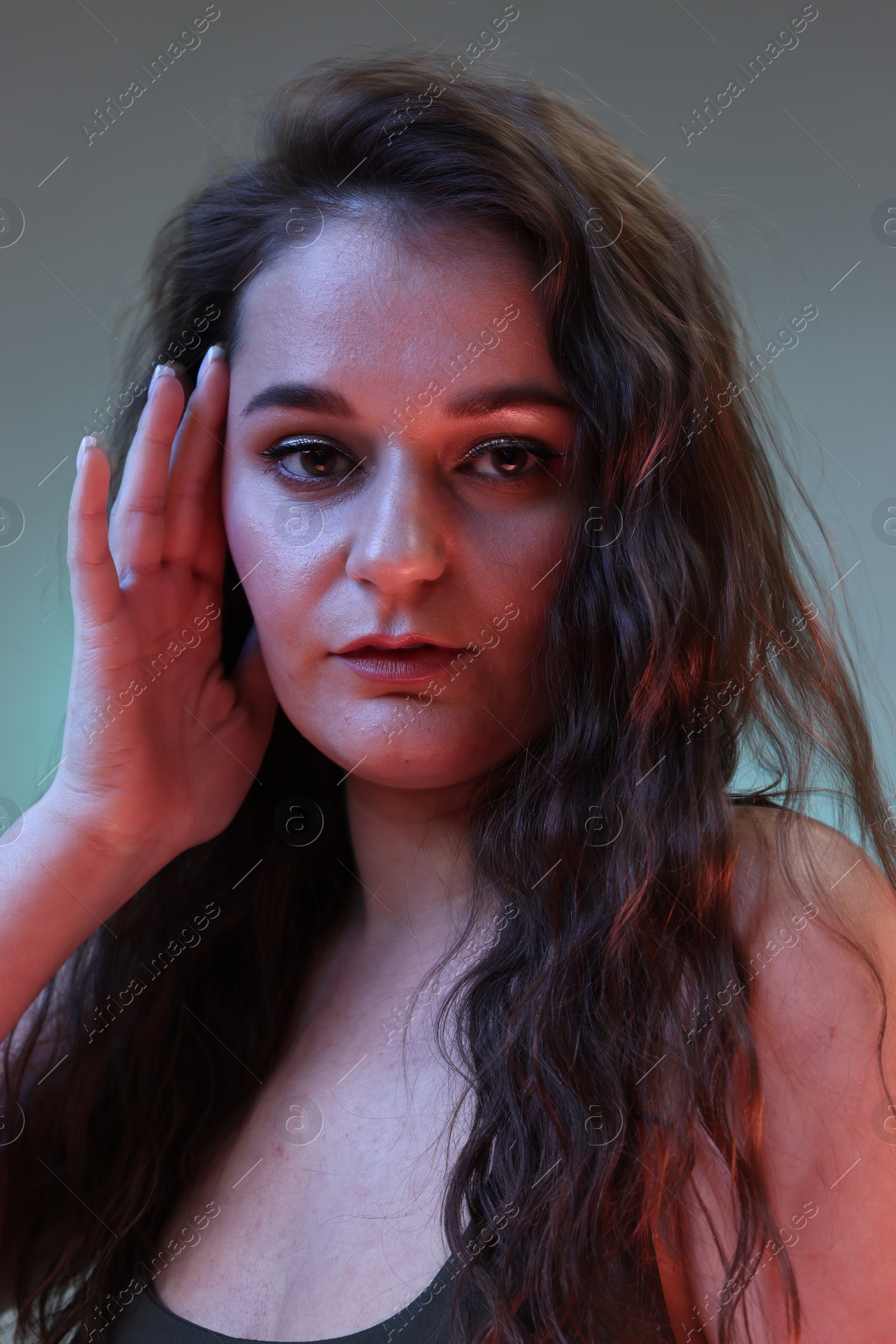 Photo of Portrait of beautiful woman on color background with neon lights