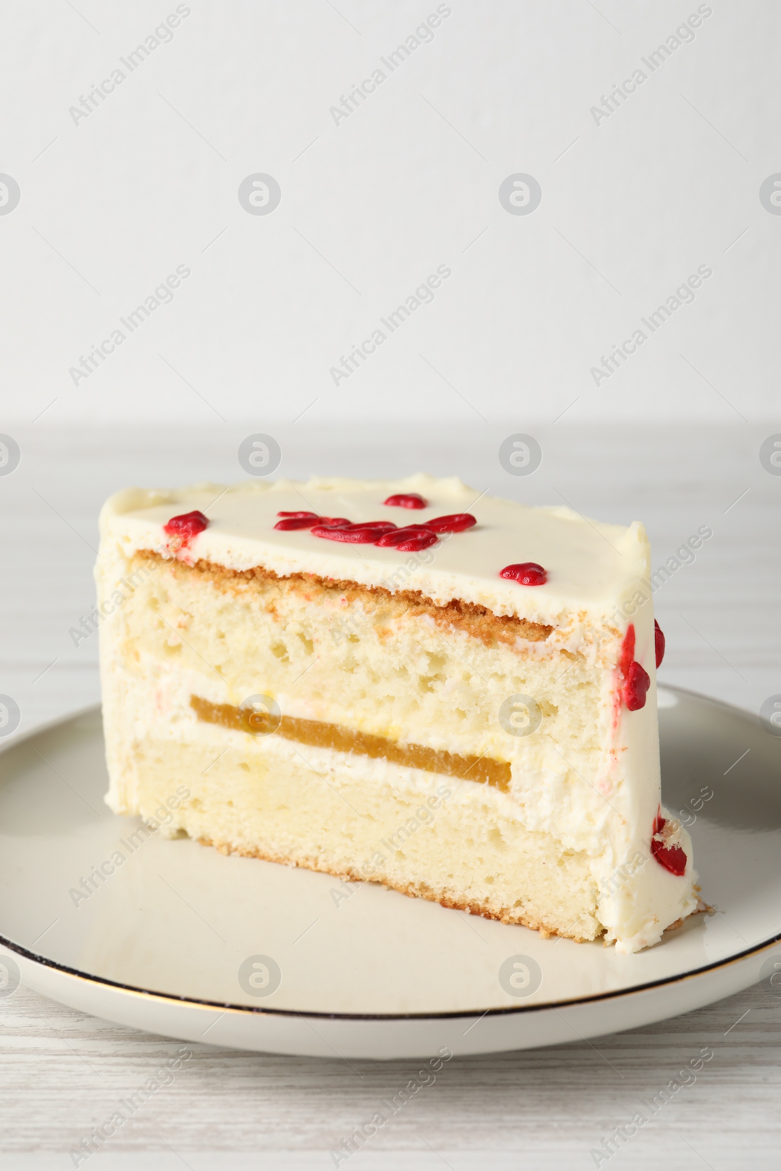 Photo of Cut bento cake on white wooden table, closeup. St. Valentine's day surprise