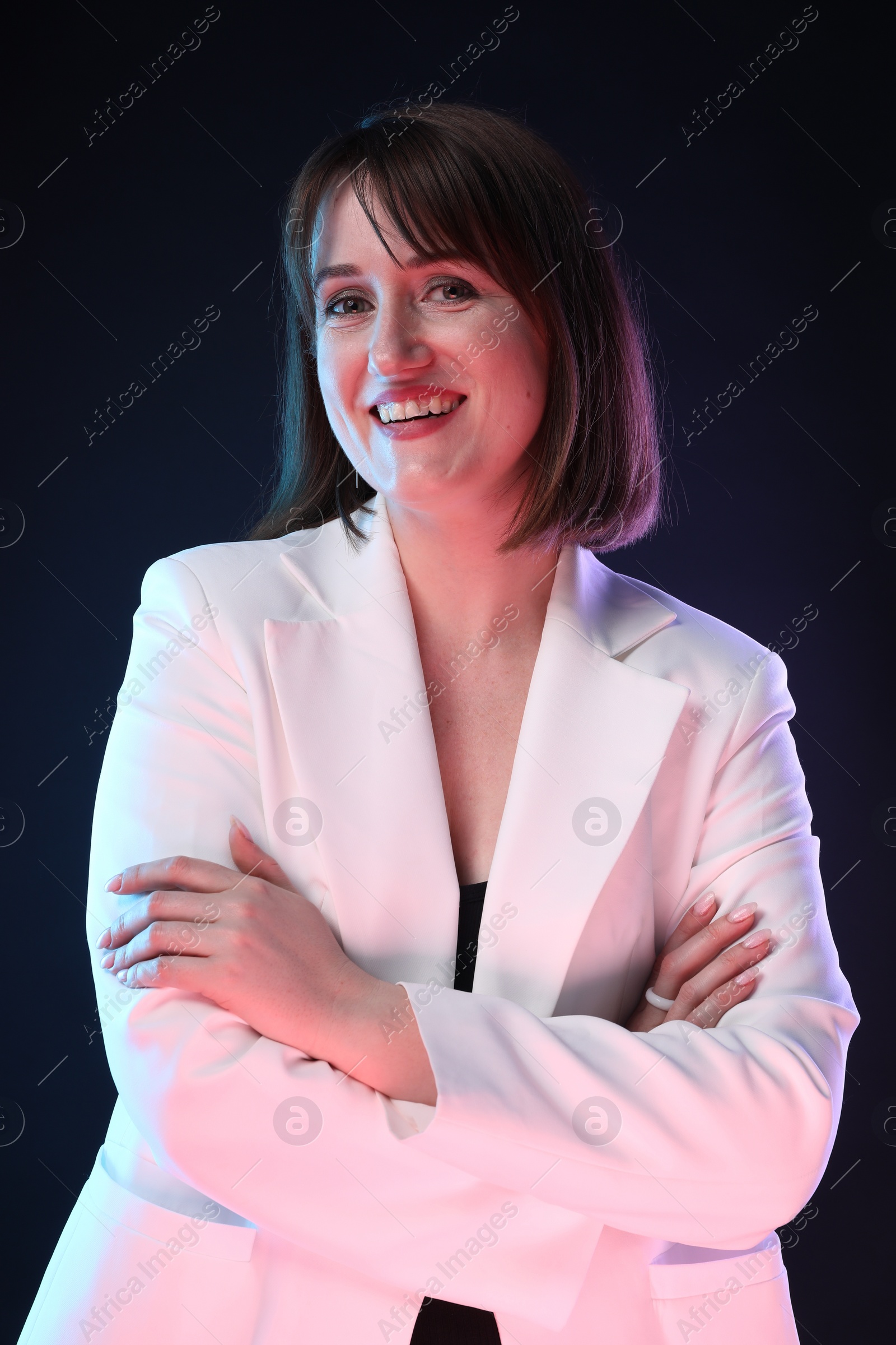 Photo of Portrait of happy woman on dark background