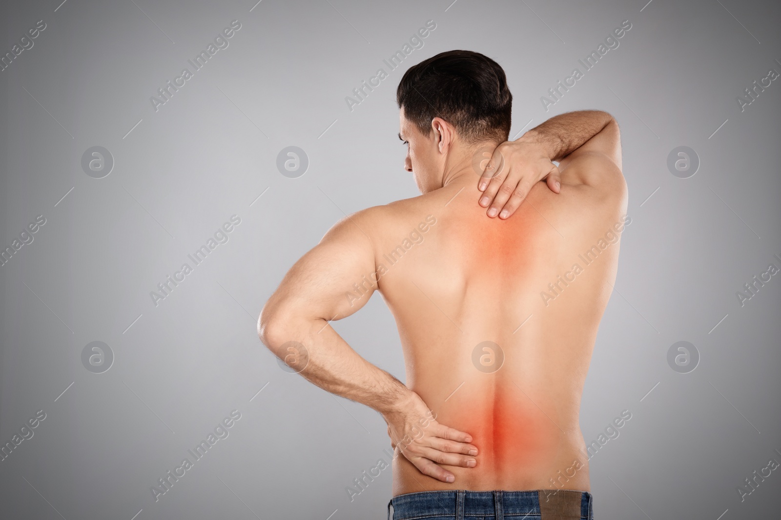 Image of Man suffering from pain in lower back on light grey background