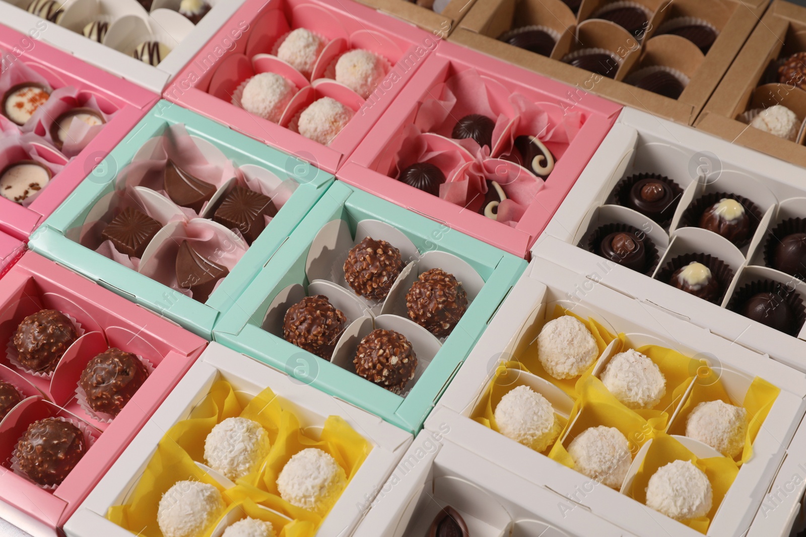 Photo of Many delicious candies in boxes. Production line