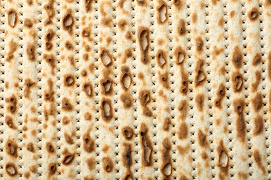 Photo of Traditional Matzo as background, top view. Pesach (Passover) celebration