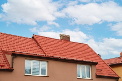 Beautiful house with red roof against blue sky