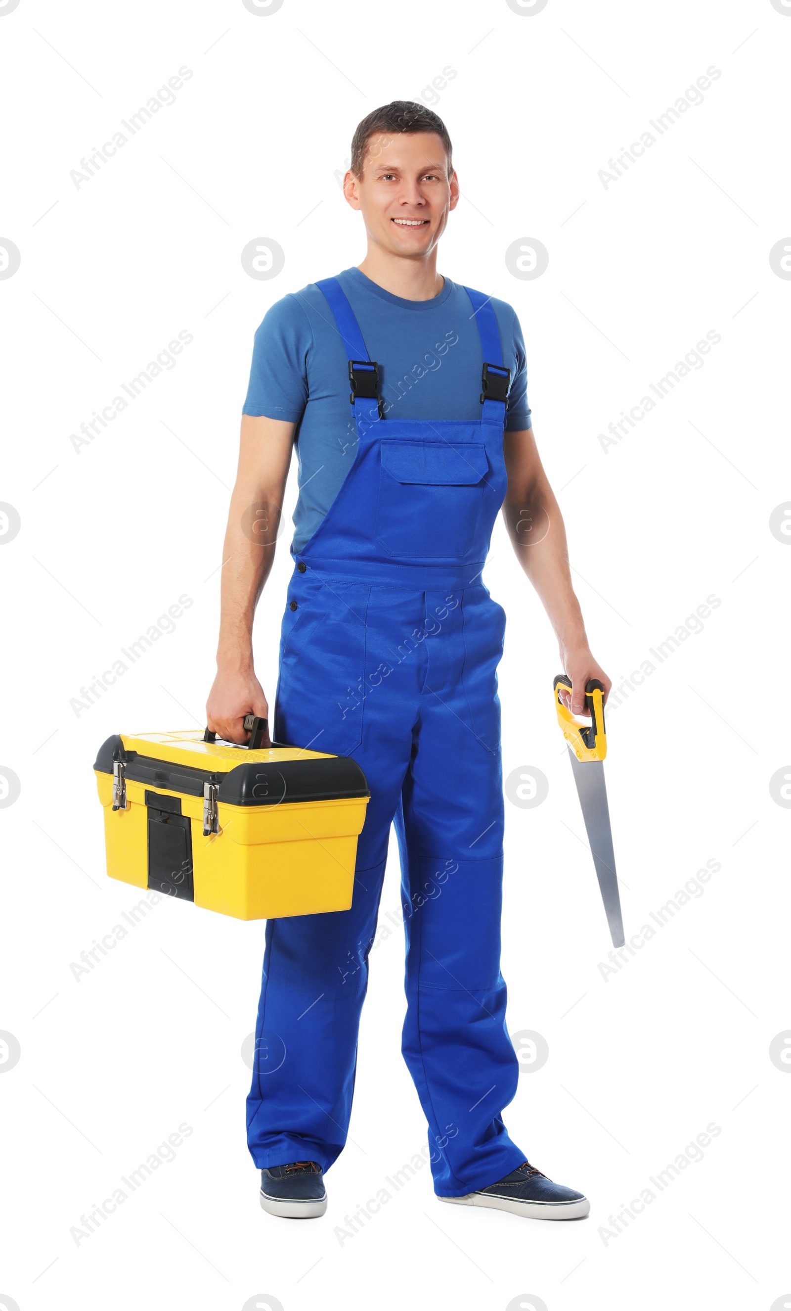 Photo of Handsome carpenter with tool box and hand saw isolated on white