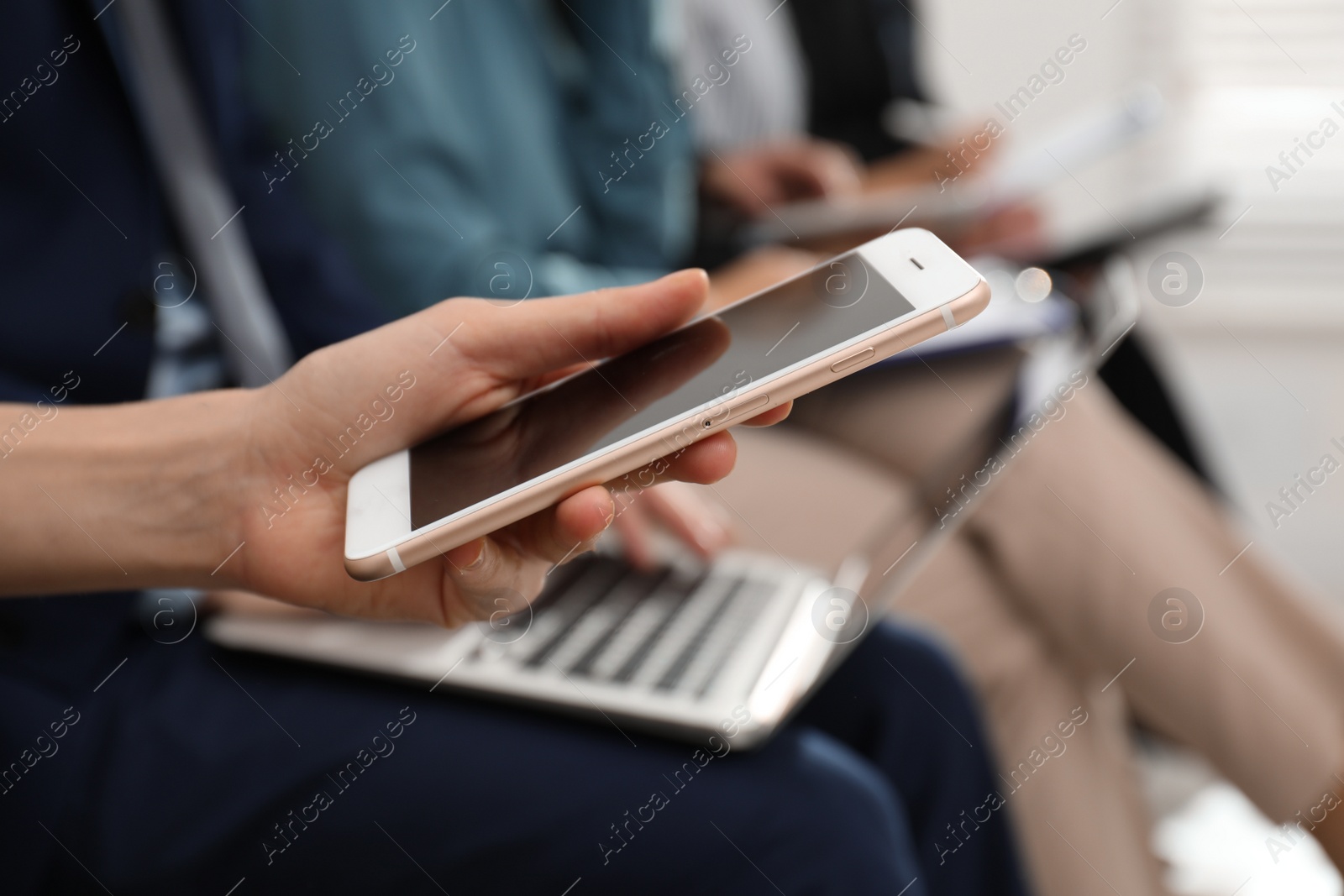 Photo of Woman with smartphone waiting for job interview in office, closeup