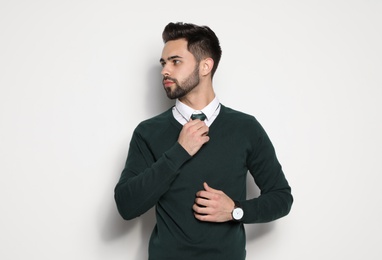 Photo of Portrait of handsome young man on light background