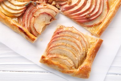 Freshly baked apple pie on white wooden table, top view