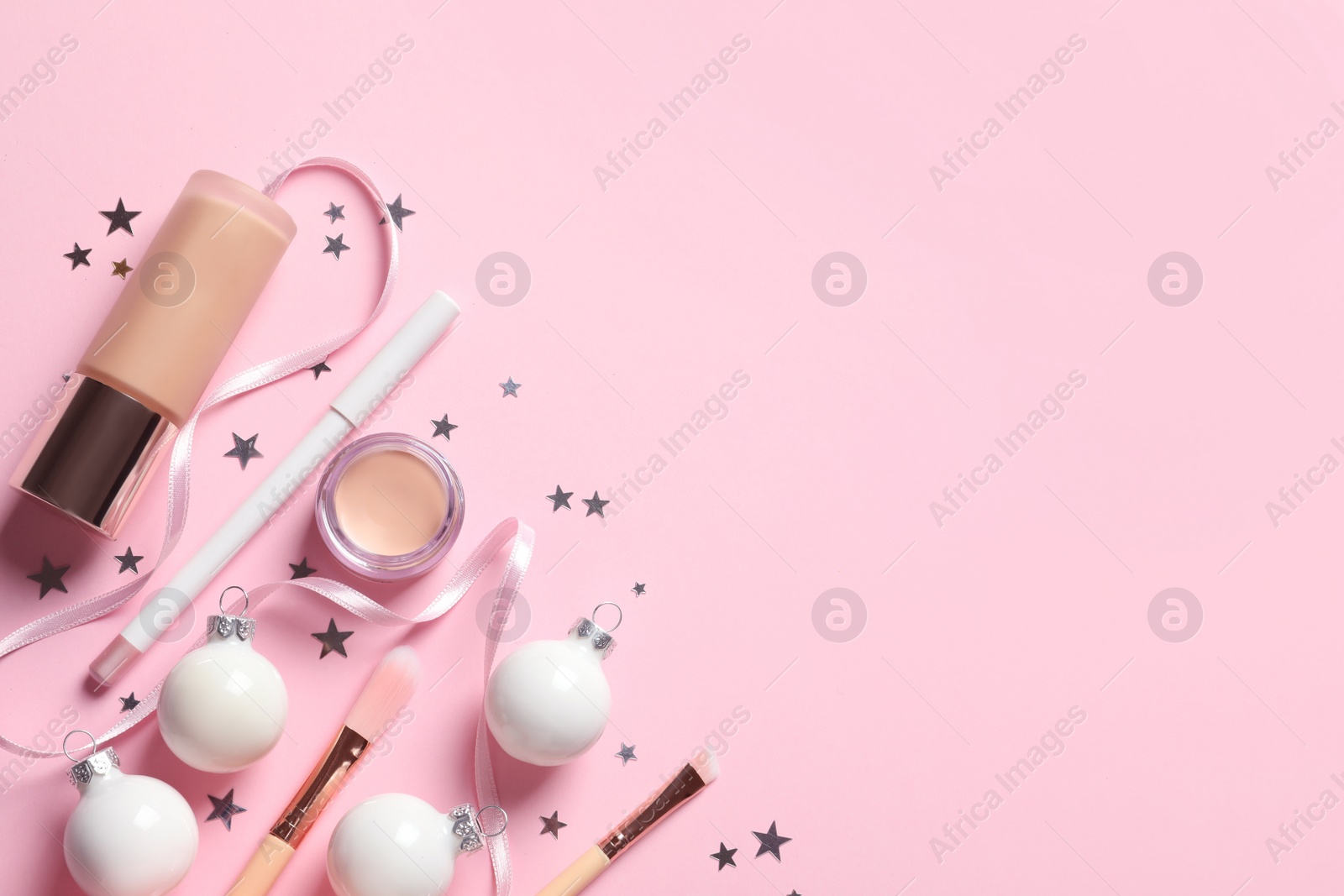 Photo of Flat lay composition with makeup products and Christmas decor on color background. Space for text