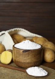 Photo of Starch and fresh raw potatoes on table. Space for text