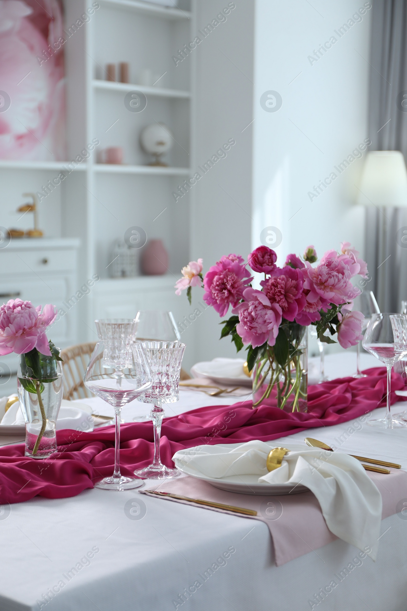 Photo of Beautiful table setting with pink peonies in dining room