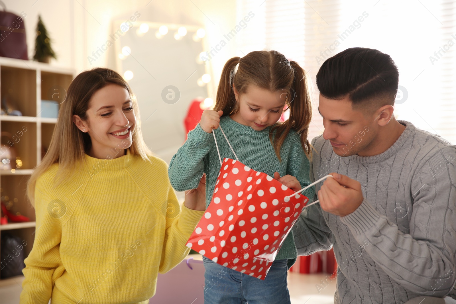 Photo of Happy family doing Christmas shopping in store