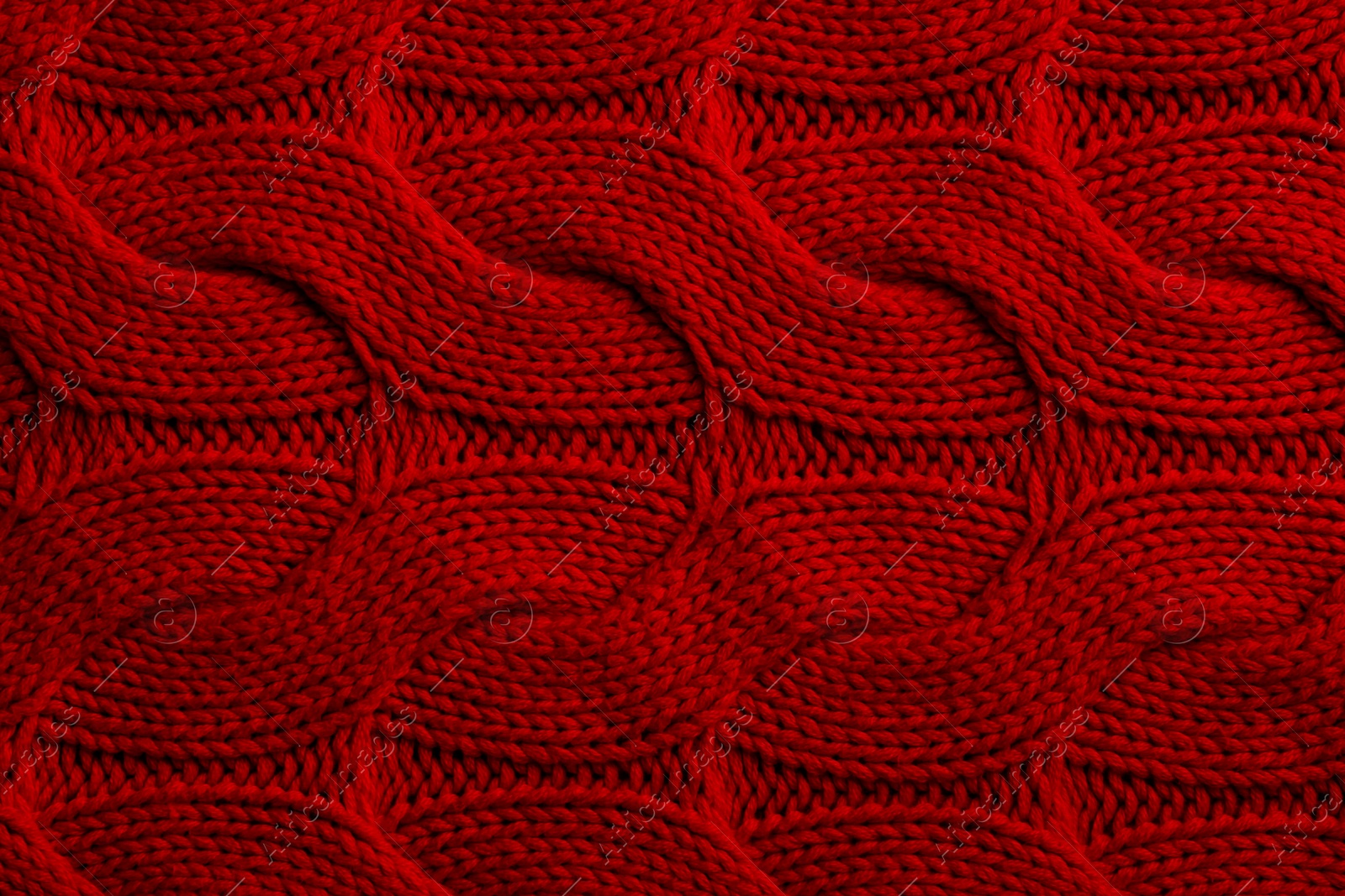 Photo of Beautiful red knitted fabric as background, top view