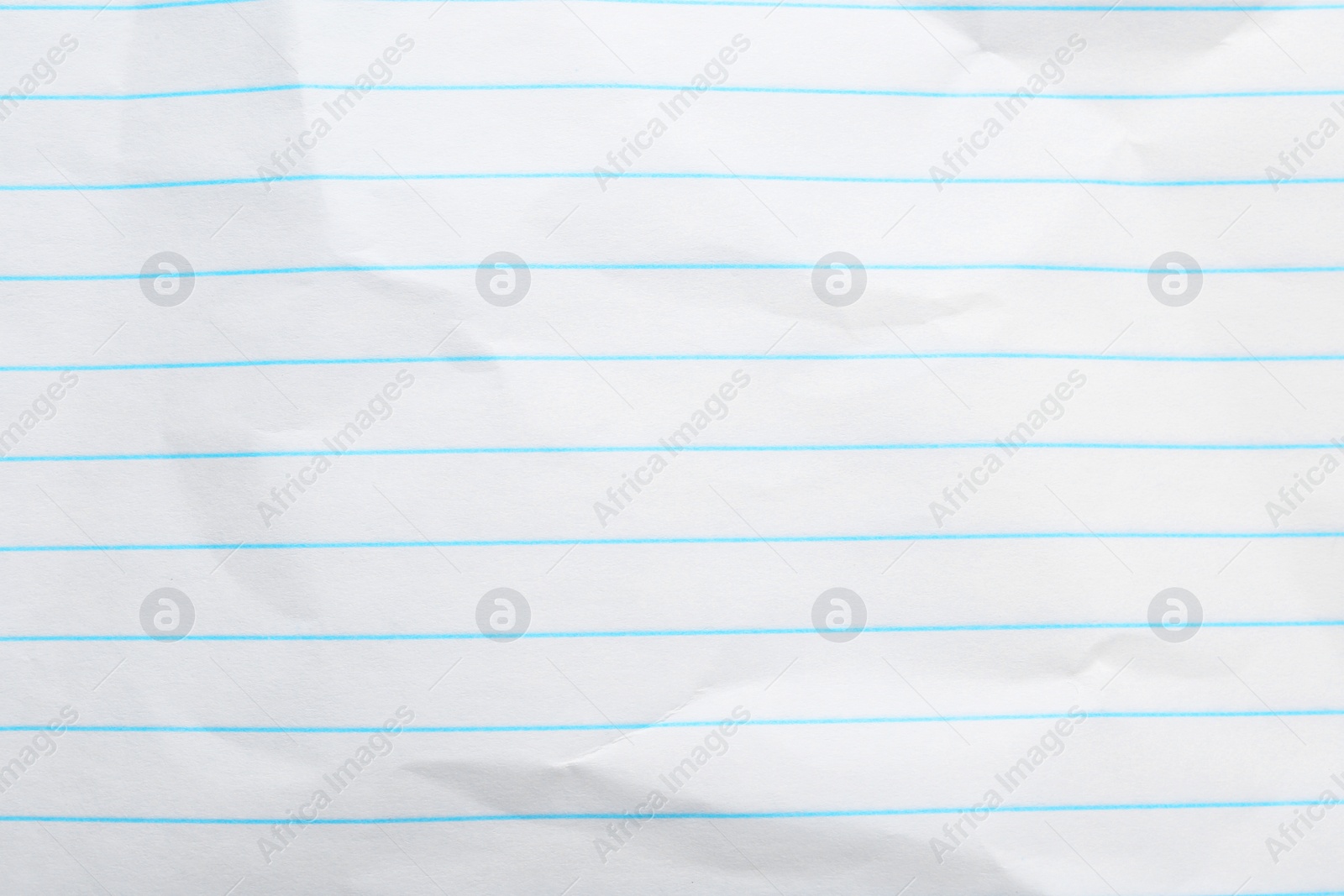 Photo of Crumpled lined notebook sheet as background, top view