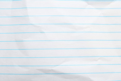 Photo of Crumpled lined notebook sheet as background, top view