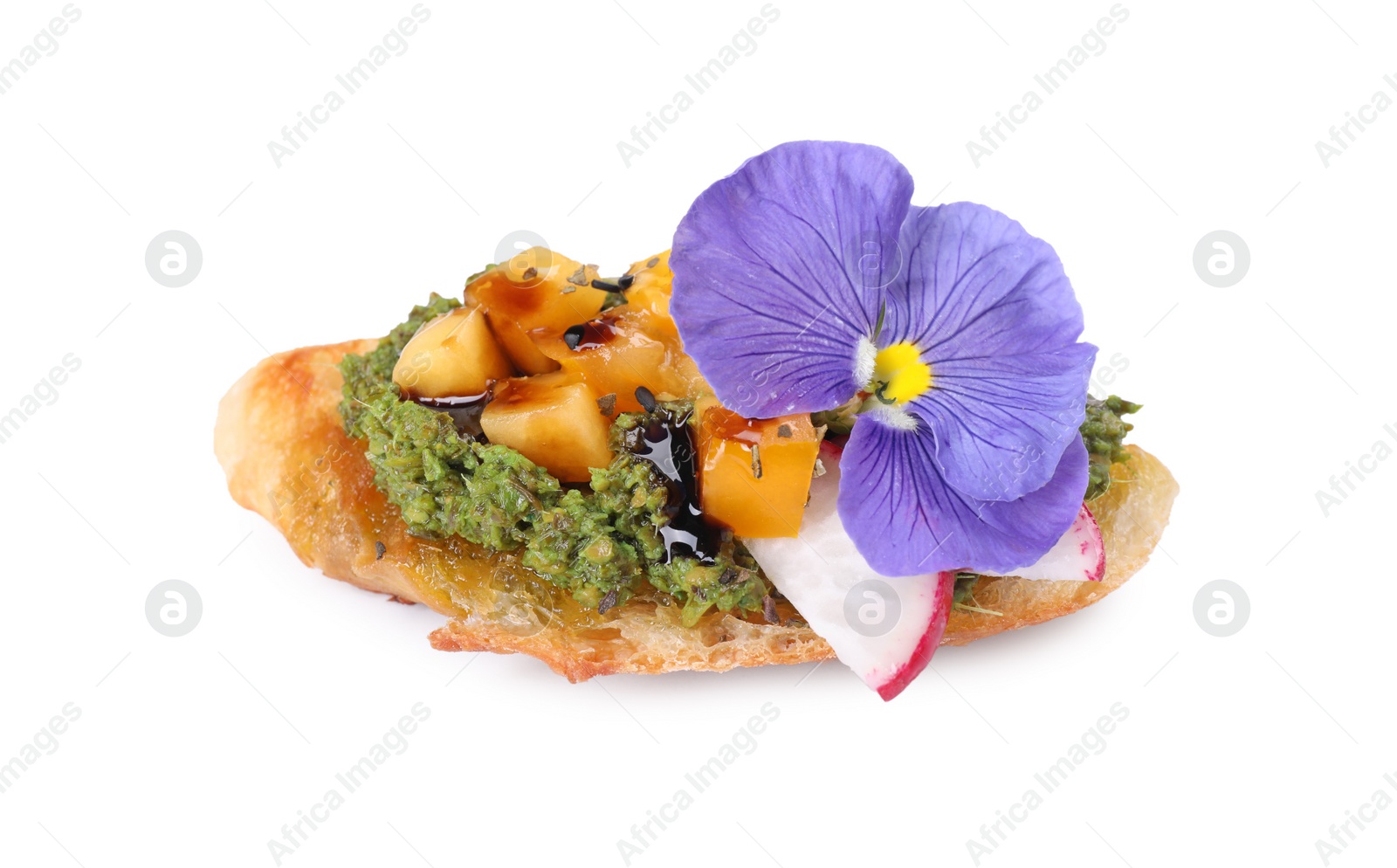 Photo of Delicious bruschetta with pesto sauce, tomatoes, balsamic vinegar and violet flower on white background