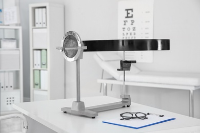 Photo of Campimeter on table in clinic. Ophthalmic equipment