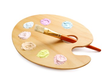 Photo of Wooden artist's palette with samples of pastel paints and brush on white background