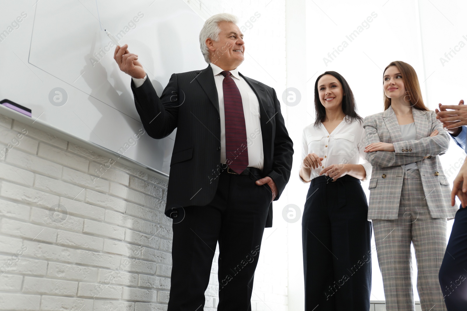 Photo of Professional business trainer working with people in office