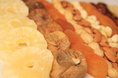 Different tasty nuts and dried fruits, closeup