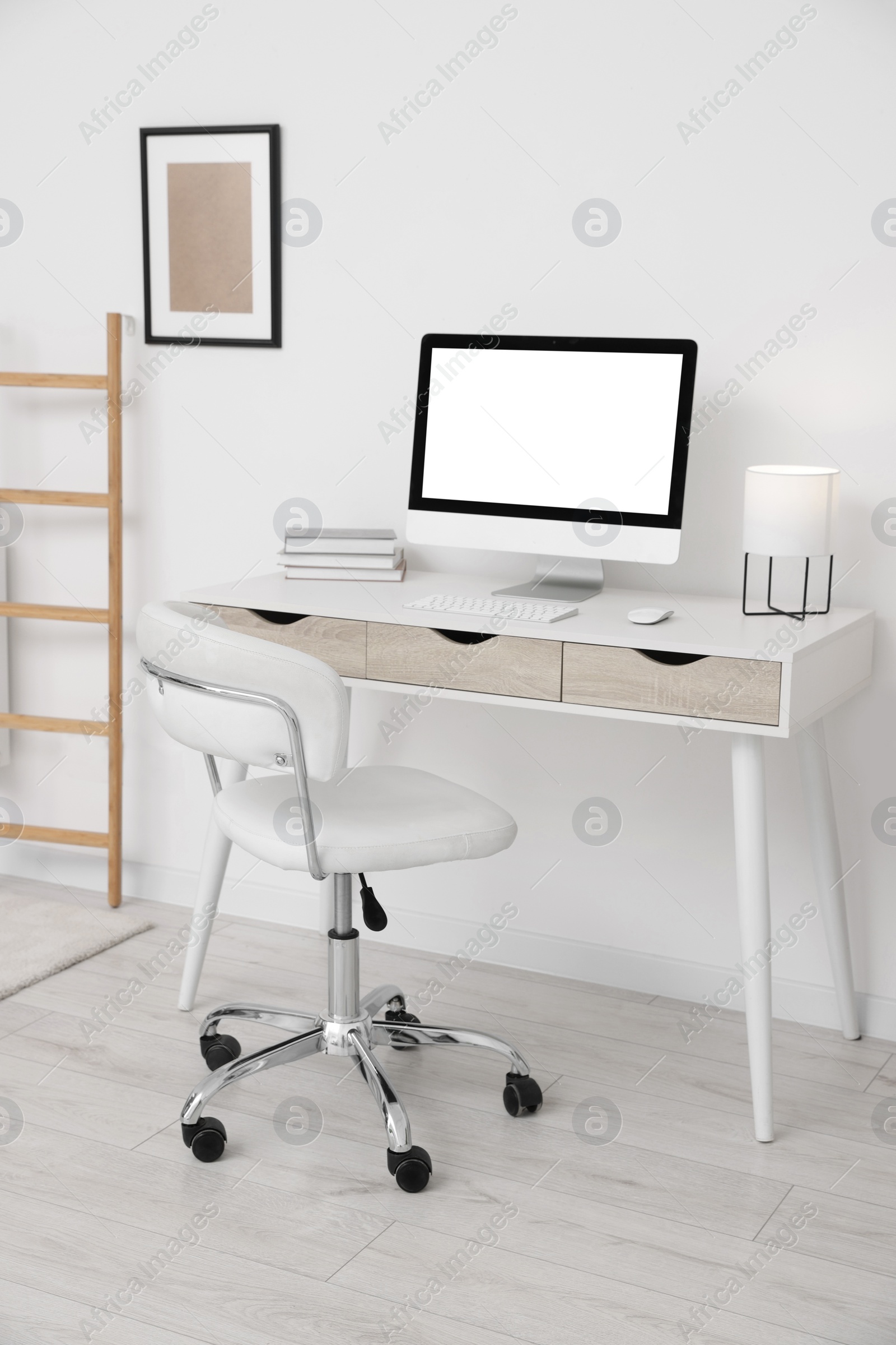 Photo of Workplace with comfortable office chair indoors. Interior design