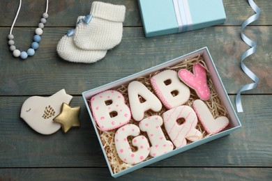 Photo of Baby shower party. Flat lay composition with open gift box and cookies on light blue wooden background