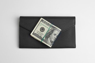 Money exchange. Dollar banknotes and wallet on white background, top view