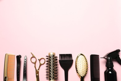 Professional hair dresser tools on pink background, flat lay. Space for text