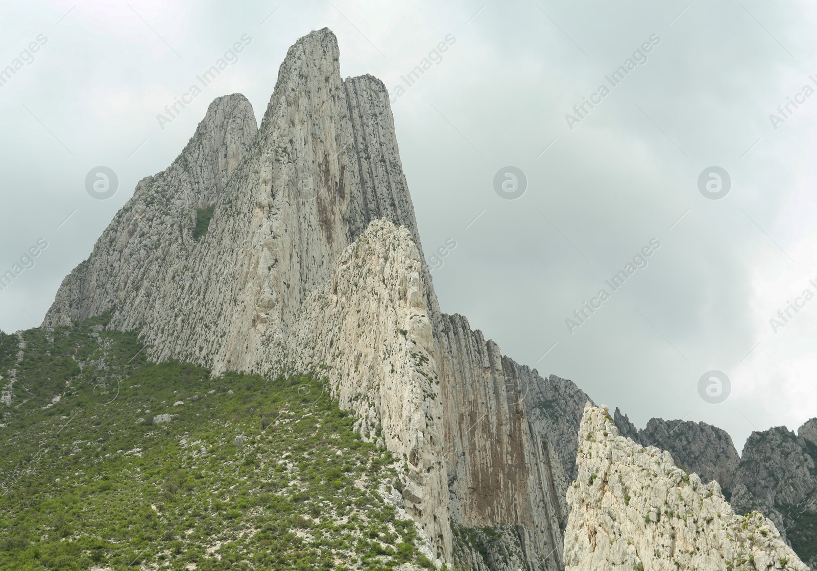 Photo of Picturesque landscape with high mountains and fog under cloudy sky