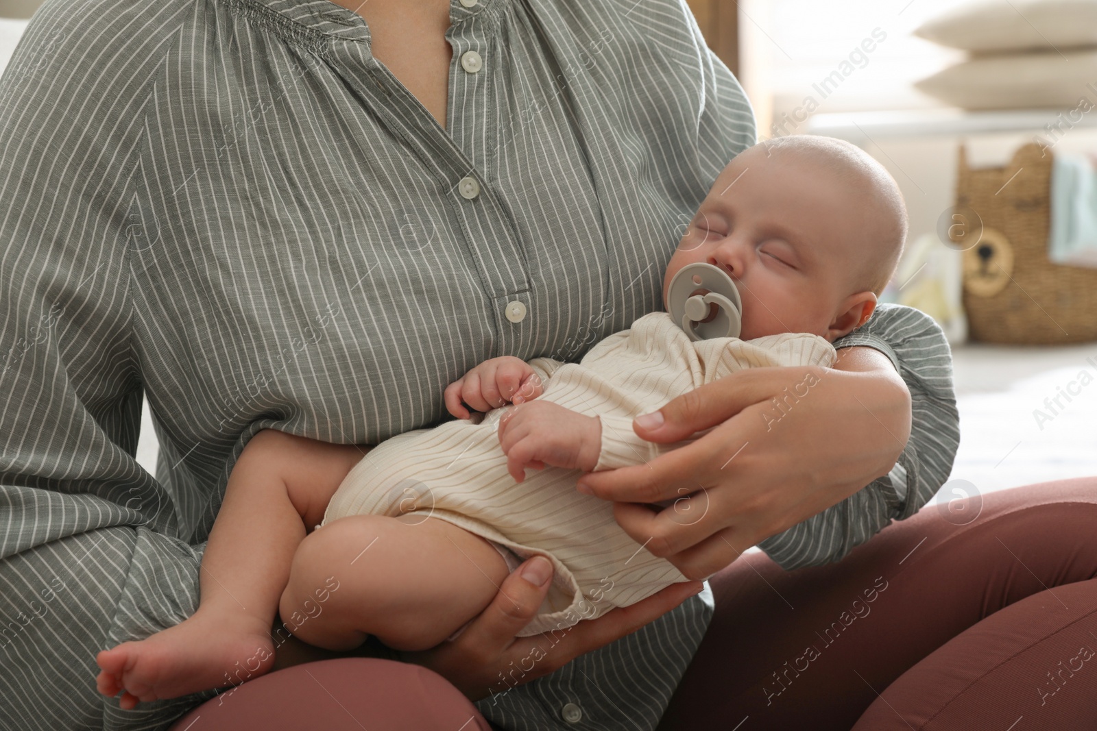 Photo of Mother with her cute sleeping baby at home, closeup