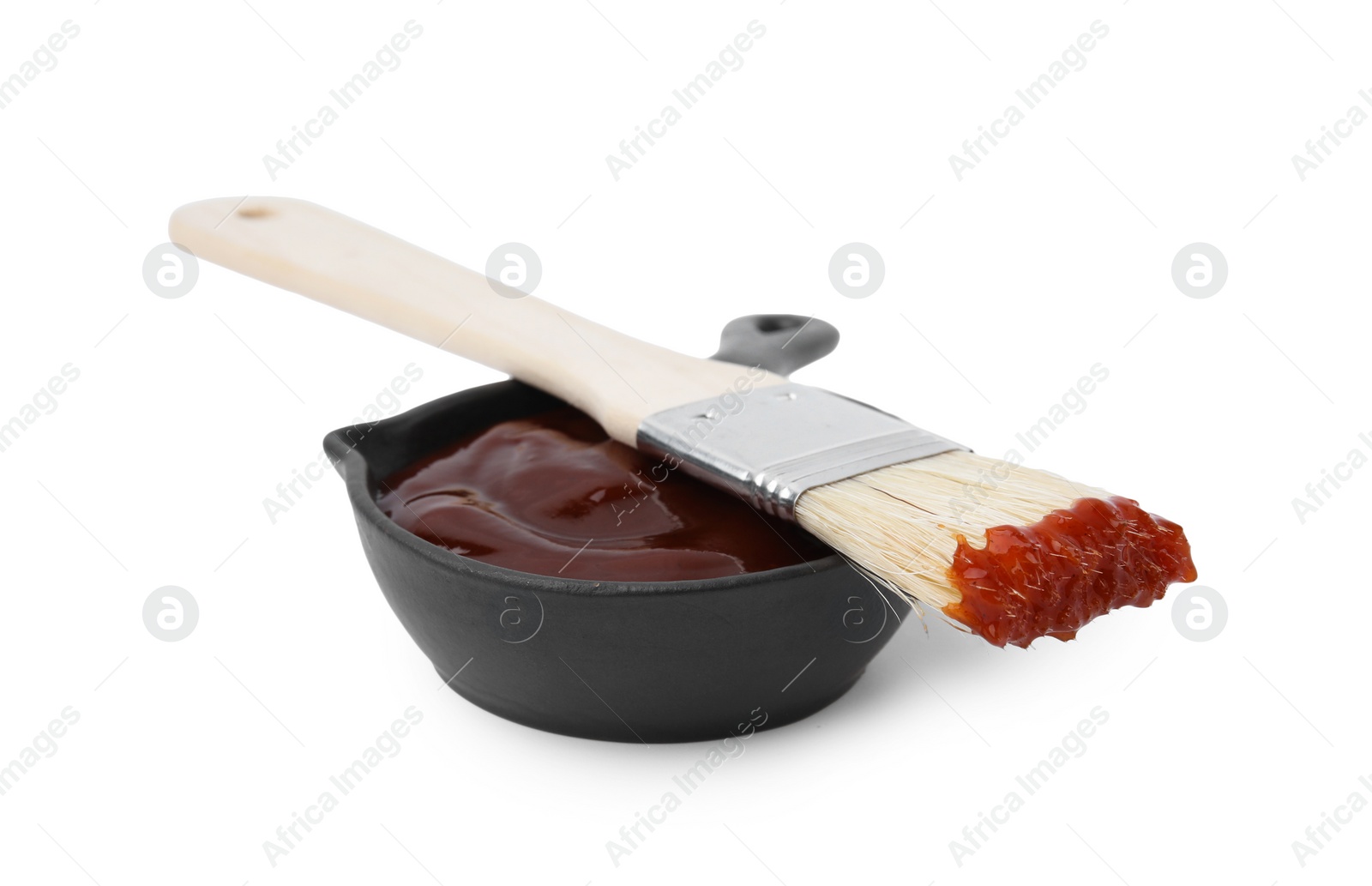 Photo of Marinade in gravy boat and basting brush isolated on white