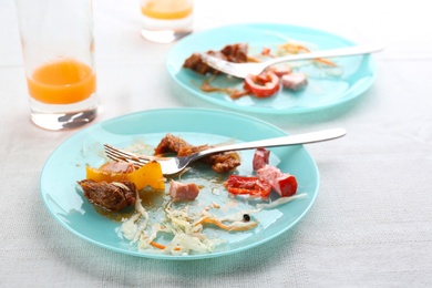 Photo of Food leftovers after party on table with cloth