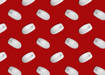 Image of Many white computer mouses on red background, flat lay. Seamless pattern design