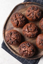 Photo of Tasty chocolate muffins on grey table, top view
