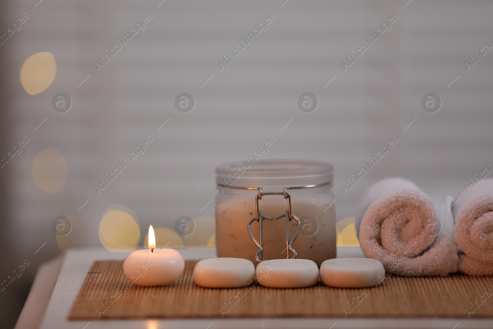 Photo of Composition with spa stones and cosmetic product on table indoors, space for text