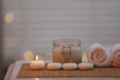 Photo of Composition with spa stones and cosmetic product on table indoors, space for text