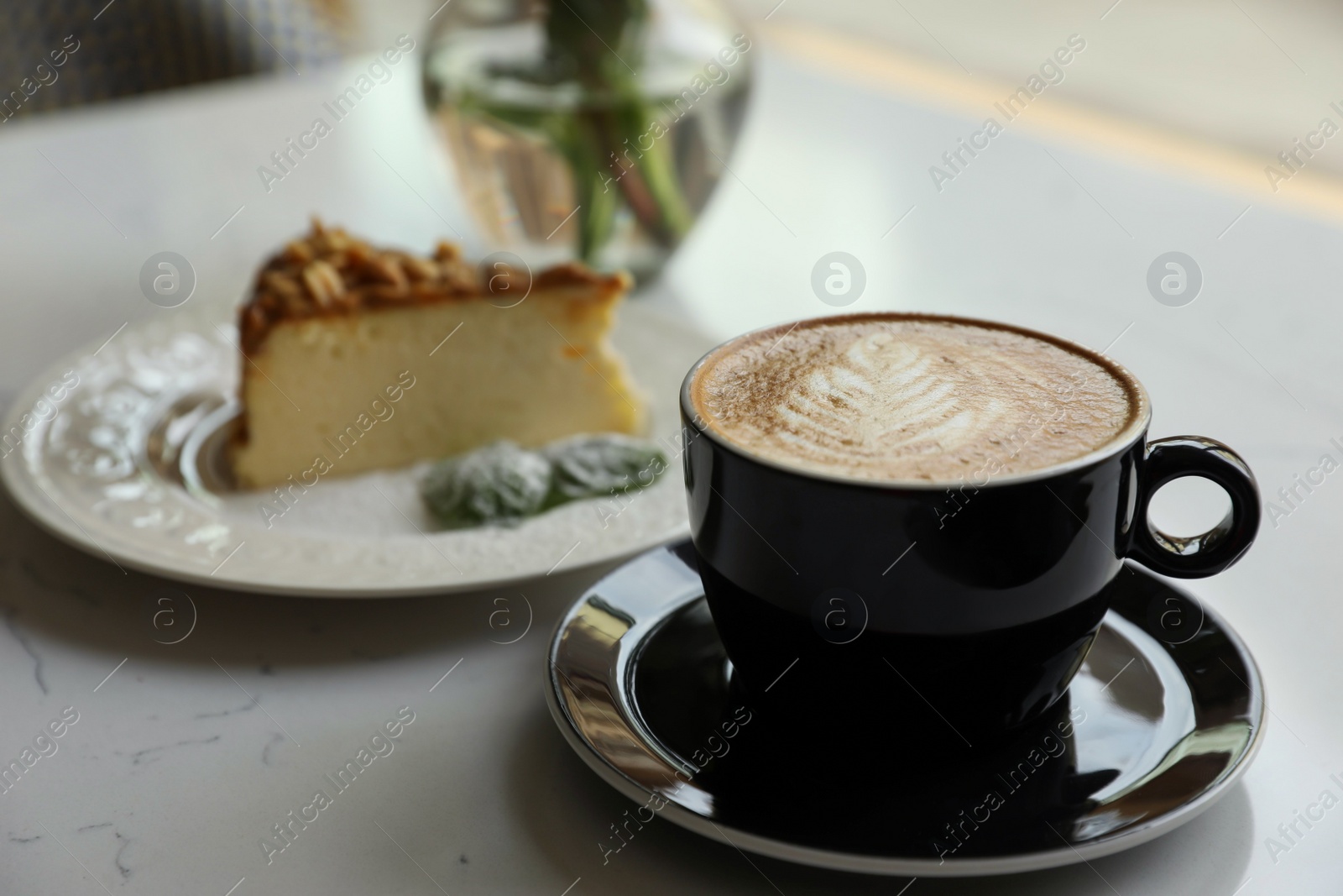 Photo of Cup of fresh coffee and dessert on table