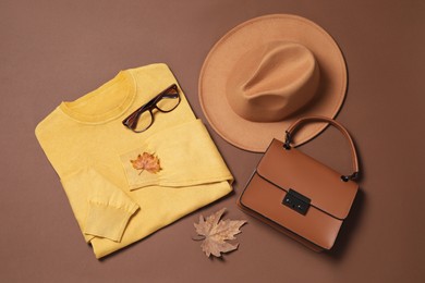 Flat lay composition with stylish hat on brown background