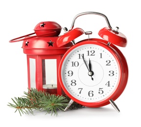 Alarm clock, lantern and fir branch on white background. New Year countdown