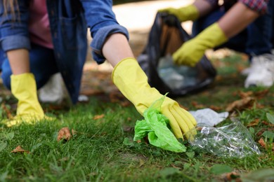 Photo of Woman collecting garbage in park, closeup view