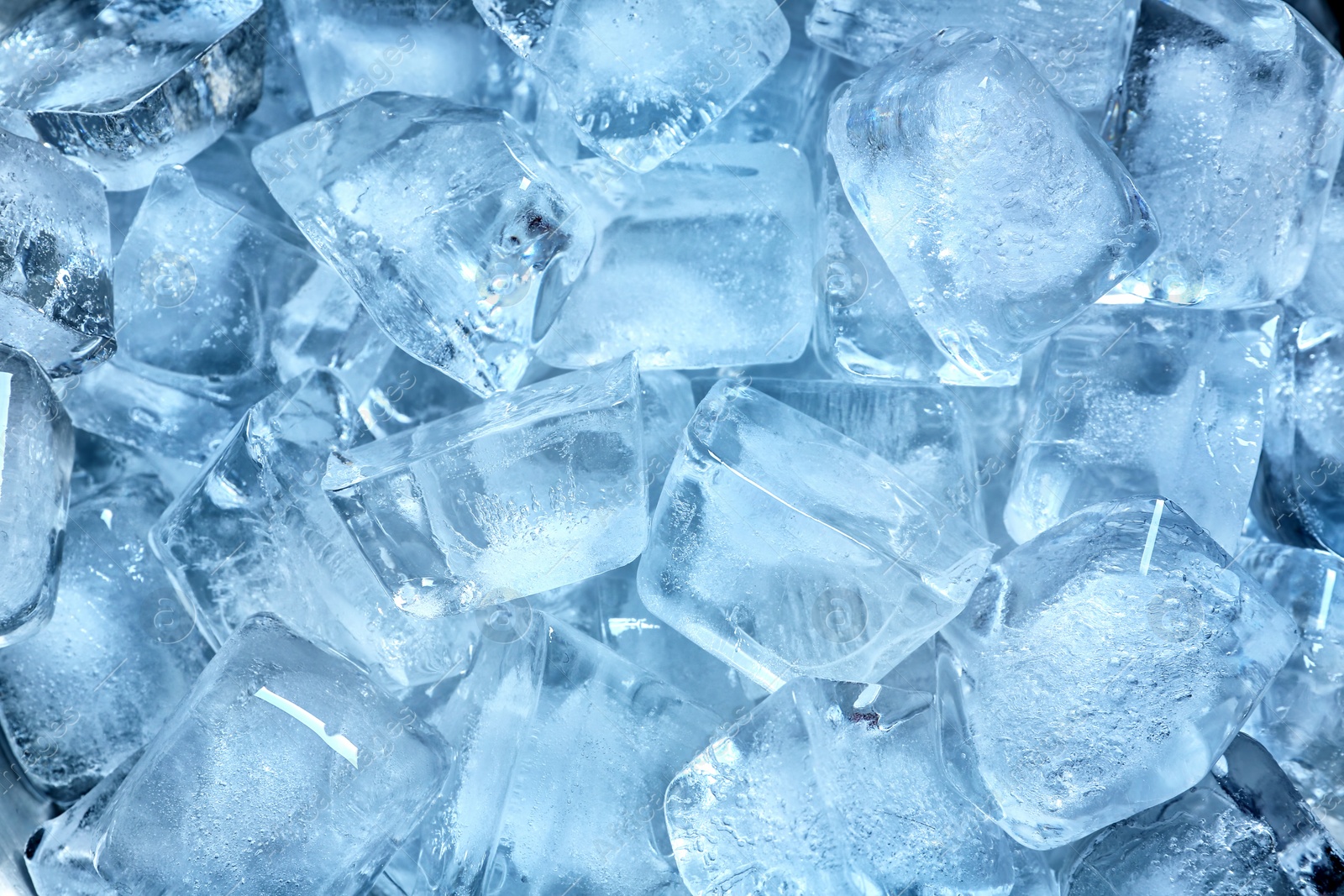 Photo of Many ice cubes on color background, top view